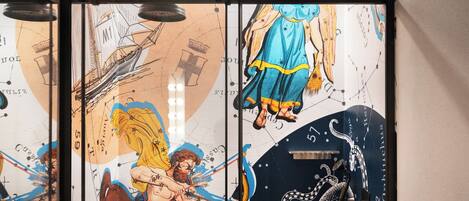 A wall with a celestial-themed mural including constellations and mythological figures.