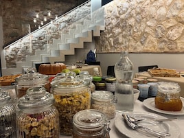 A breakfast buffet with various food items and condiments.
