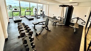 A gym with treadmills, elliptical machines, and free weights. - 2BR Condo Near Beach: Private Jacuzzi & 2 Bikes (Tulum)