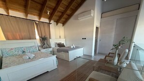 A bedroom with a bed, bedside tables, a dresser, a mirror, and a window with curtains.