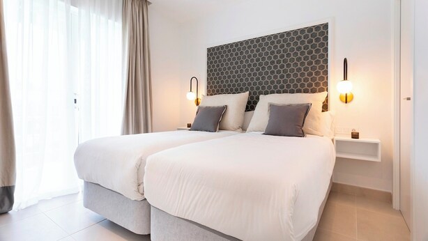 A double bed with a grey headboard and two bedside tables with lamps. - 2 Bedroom With Private Terrace and Communal Pool in Marbella Center Ricardo Soriano Terrace (Marbella)