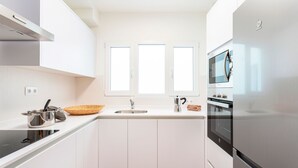 A modern kitchen with white cabinets, a stainless steel refrigerator, a microwave, and a built-in oven. - Amazing Apartment 5 Bd in the Heart of Granada Alh Ndiga (Granada)