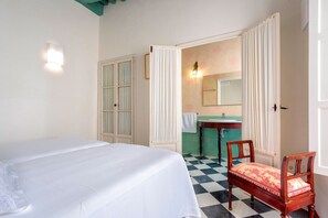 A room with a bed, a chair, a mirror, and a sink. - Beautiful 4 Bd House With Terrace Views to the Alcazar Gardens Casa Alcazar (Seville)
