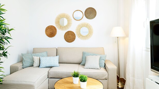 A living room with a sofa, a round coffee table, and wall decor. - Magnificent Penthouse in the Center of Malaga Marin Garcia V (Málaga)