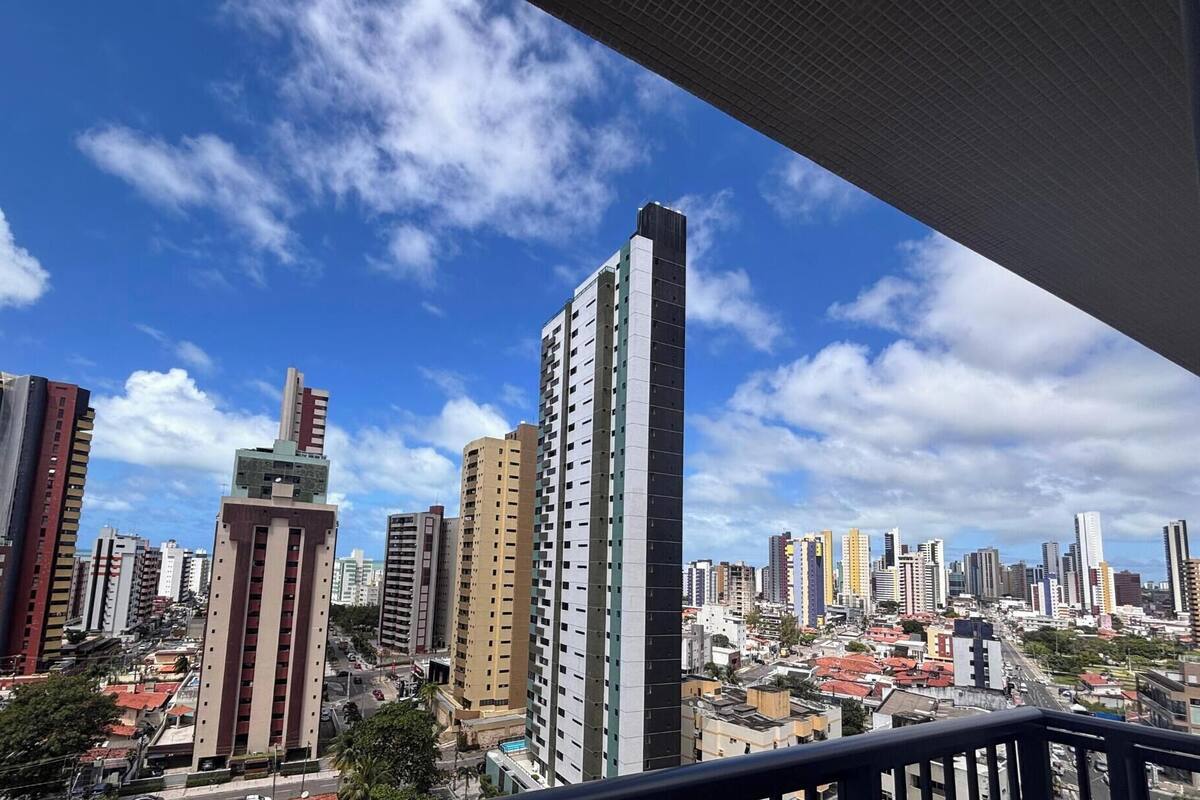 A cityscape with high-rise buildings, a clear sky, and a LikeHome logo.