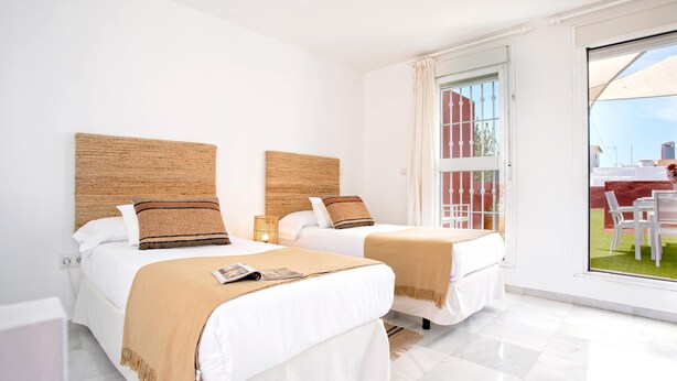 A hotel room with two beds, a large window, and a view of the outside. - Wonderful Large 4 BD Duplex With a Private Terrace Salvador Terrace (Seville)
