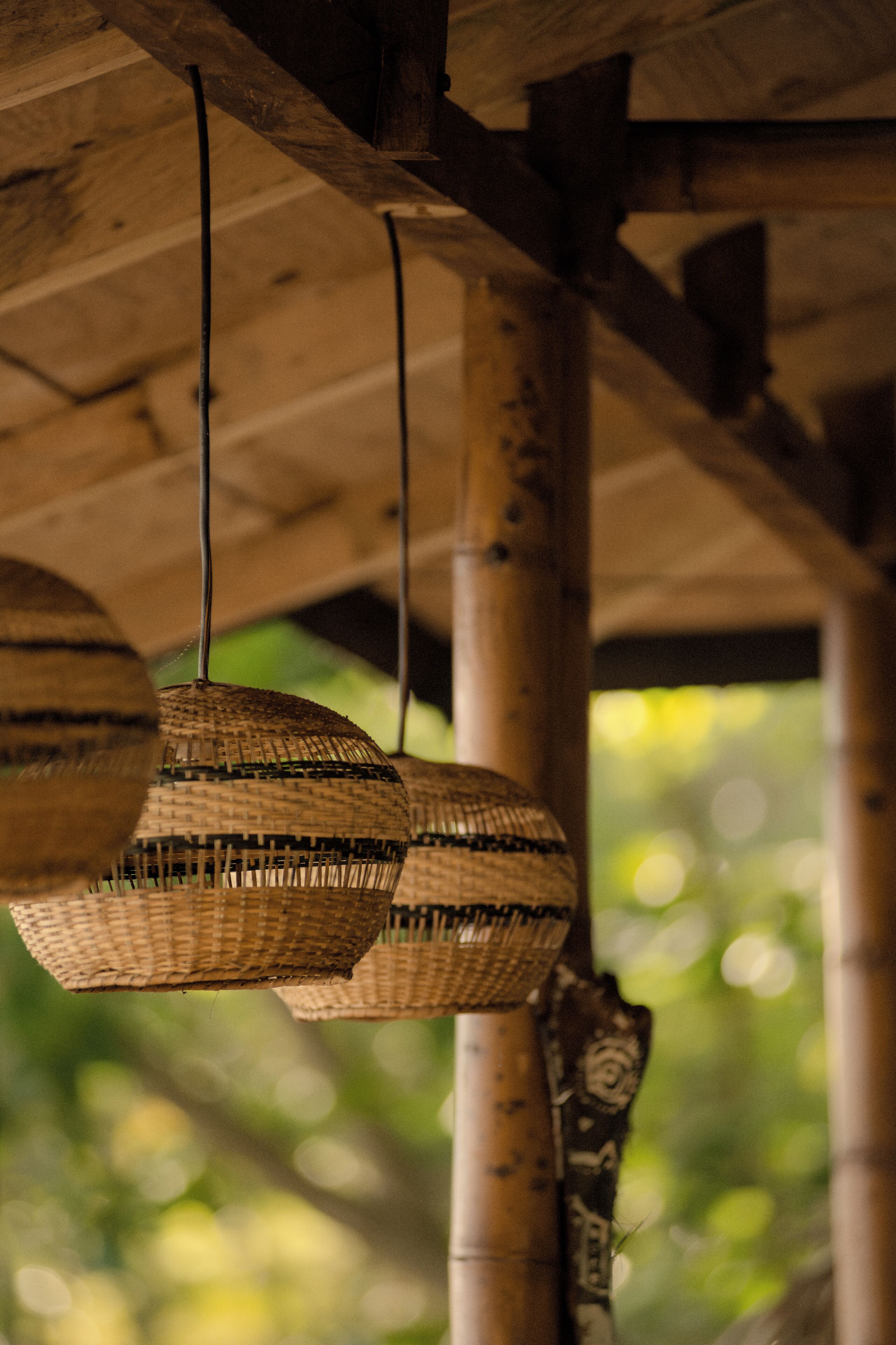 A wooden structure with hanging woven baskets.