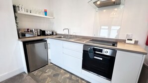 A modern kitchen with a dishwasher, oven, and countertop appliances.