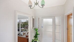 A hallway with a frosted glass door, a white wall, and a ceiling light fixture. - Heritage on Liebig - Perch at the top of town (Warrnambool)