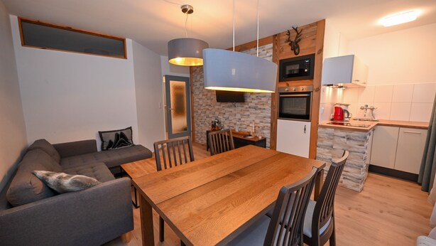 A modern kitchen with a built-in oven, microwave, and a red coffee maker. - Domizil Alpine Retreat 15 With Balcony (Kaprun)