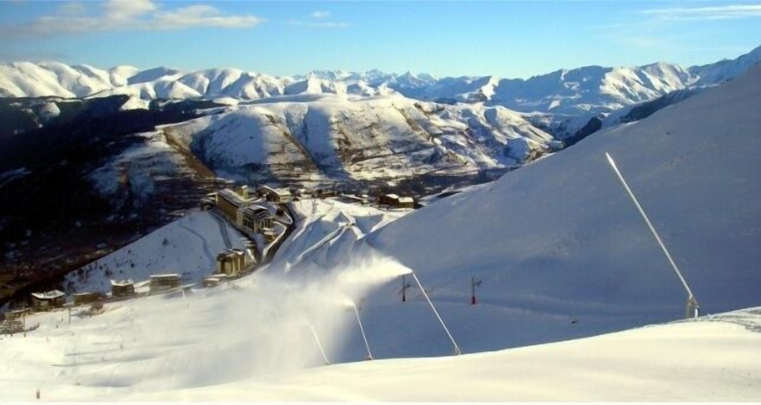 A snow-covered mountain landscape with a ski resort.