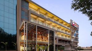 A modern multi-story hotel with a prominent signage for "Mansara Encore." - Ramada Encore By Wyndham Viramgam (Viramgam)