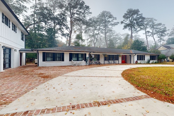 Enjoy a serene retreat in this charming single-story home with a cozy porch and beautifully manicured lawn.