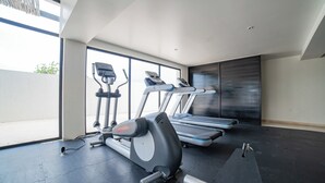 A gym with treadmills, stationary bikes, and a rowing machine. - Wellness Suite with Spa, Gym & Rooftop (Tulum)