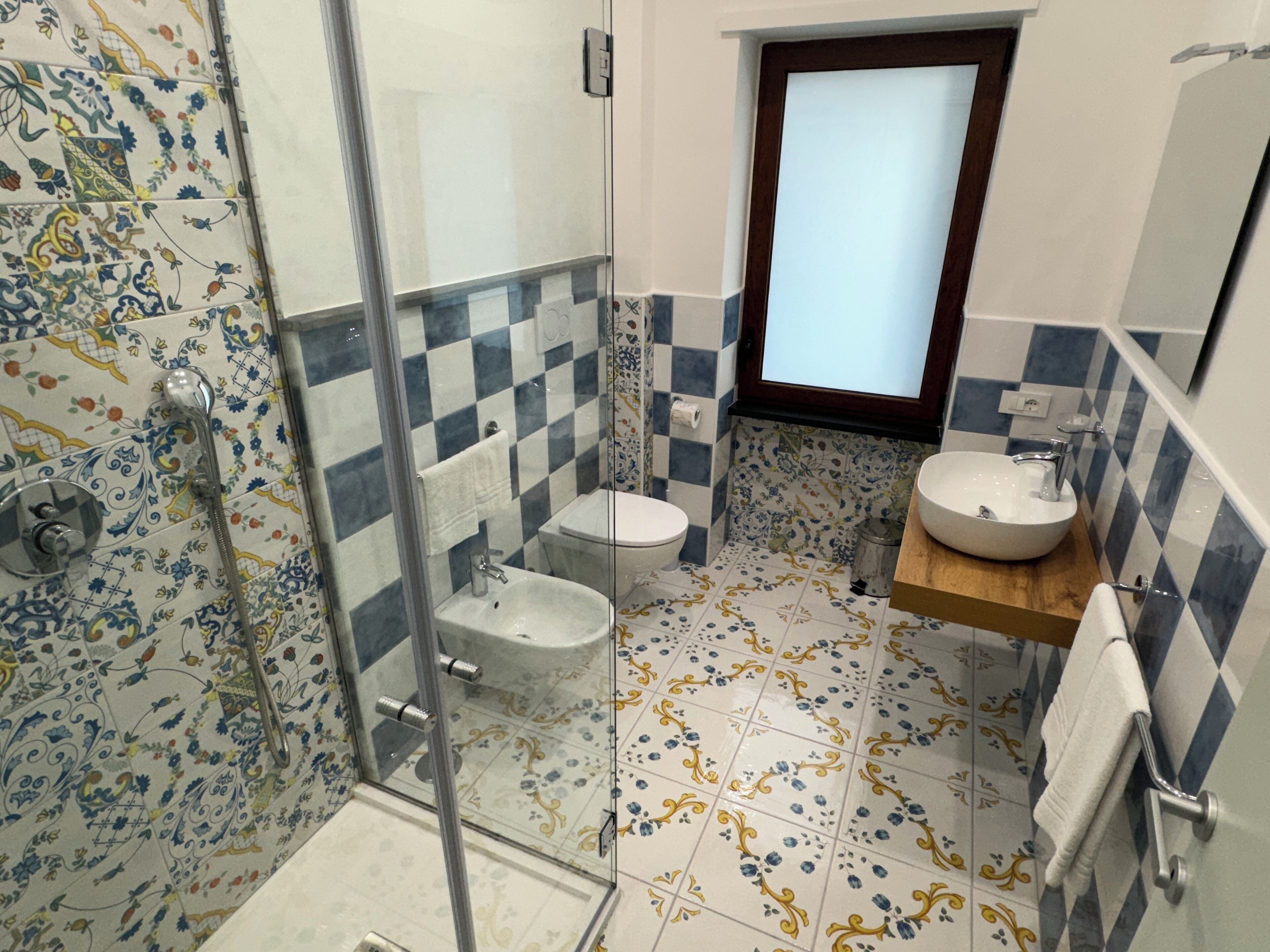 Une salle de bain avec douche, toilettes et lavabo.