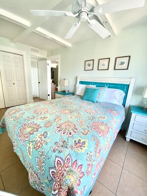 A bedroom with a bed, a ceiling fan, a nightstand, and a dresser. - Location! Unit 110 Island Winds East Sleeps 6 (Gulf Shores)