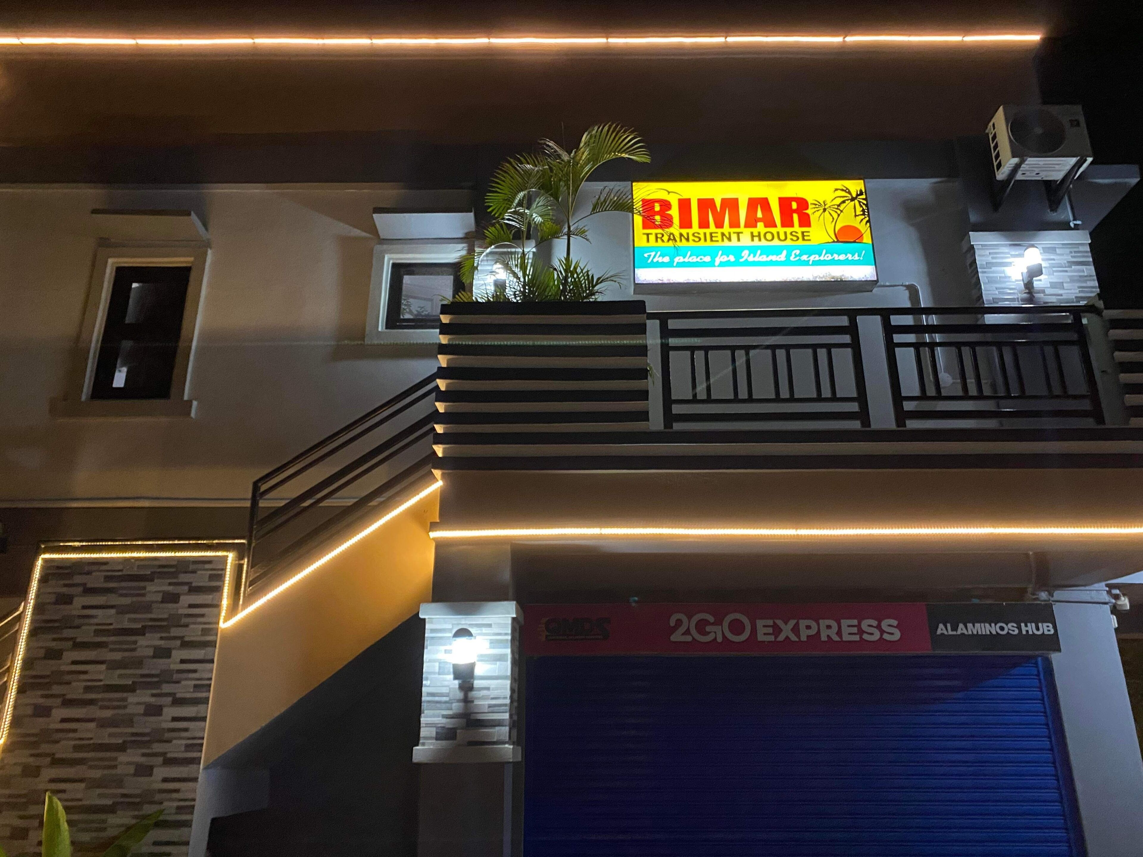 A building with a sign for 'BIMAR Transient House' and a 2GO Express Alaminos Hub.