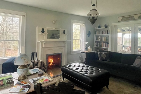 Spacious, light-filled living room with a wood-burning fireplace