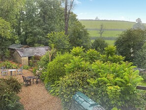 A garden with a gazebo, a small shed, and a table with chairs. - 1 bedroom accommodation in Llanboidy, Whitland (Llanboidy, Whitland)
