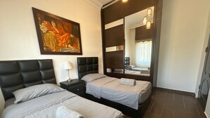 A hotel room with two beds, a large mirror, and a painting on the wall. - Central Secured Compound w/ Hill-view Terrace (Amman)