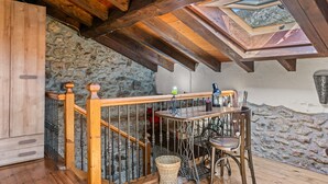A wooden staircase with a stone wall, a wooden railing, and a skylight. - Apartment 'La Breval' with Mountain View, Private Terrace and Private Garden (Alles)