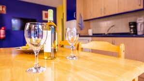 A wooden table with two wine glasses and a bottle of wine. - Apartment 'Nautilus 7' with Private Terrace and Wi-Fi (Puerto Naos)