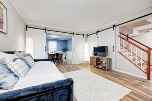 Una camera da letto moderna con un letto, un mobile TV e una scala.