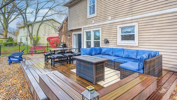 A deck with outdoor furniture, a sofa, and a table.
