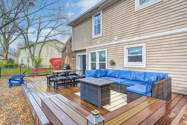 A deck with outdoor furniture, a sofa, and a table.