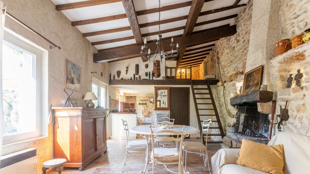 A rustic interior with exposed beams, a fireplace, a dining area, and a staircase leading to an upper level. - Holiday Home 'Maison - Les Bergeries De Danielle' with Private Pool, Private Terrace and Wi-Fi (Draguignan)