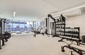 A modern gym with cardio machines, free weights, and dumbbells. - New 2B2B near Stanley Marketplace (Aurora)