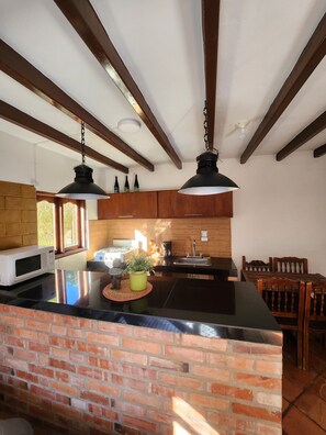 Family Apartment, Garden View | Private kitchen | Mini-fridge, microwave, stovetop, cookware/dishes/utensils