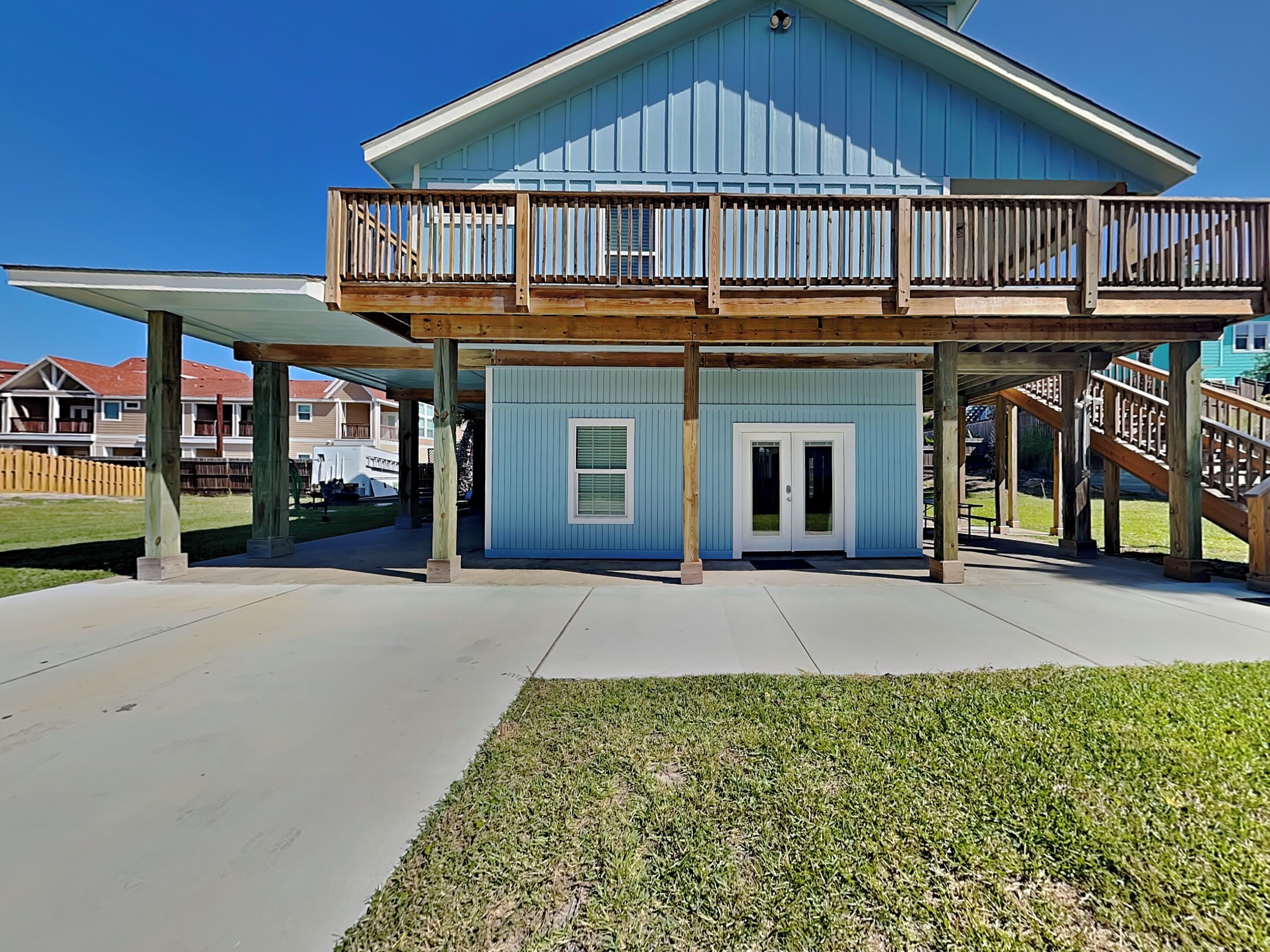 A two-story house with a covered porch and a balcony.