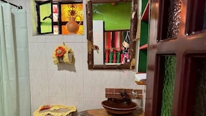 A bathroom with a toilet, sink, and mirror.