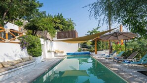 A swimming pool with lounge chairs and a canopy. - Luxury House Pool fire Pit & Lake view (Jojutla)