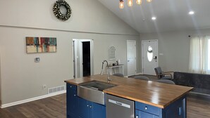 A spacious kitchen with a wooden island, a built-in dishwasher, and a pendant light fixture. - Charming countryside home in the heart of Amish Country (Fredericktown)