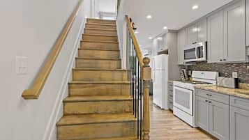 Enjoy cooking in this well-equipped kitchen with a gas stove, microwave, and stainless steel refrigerator.