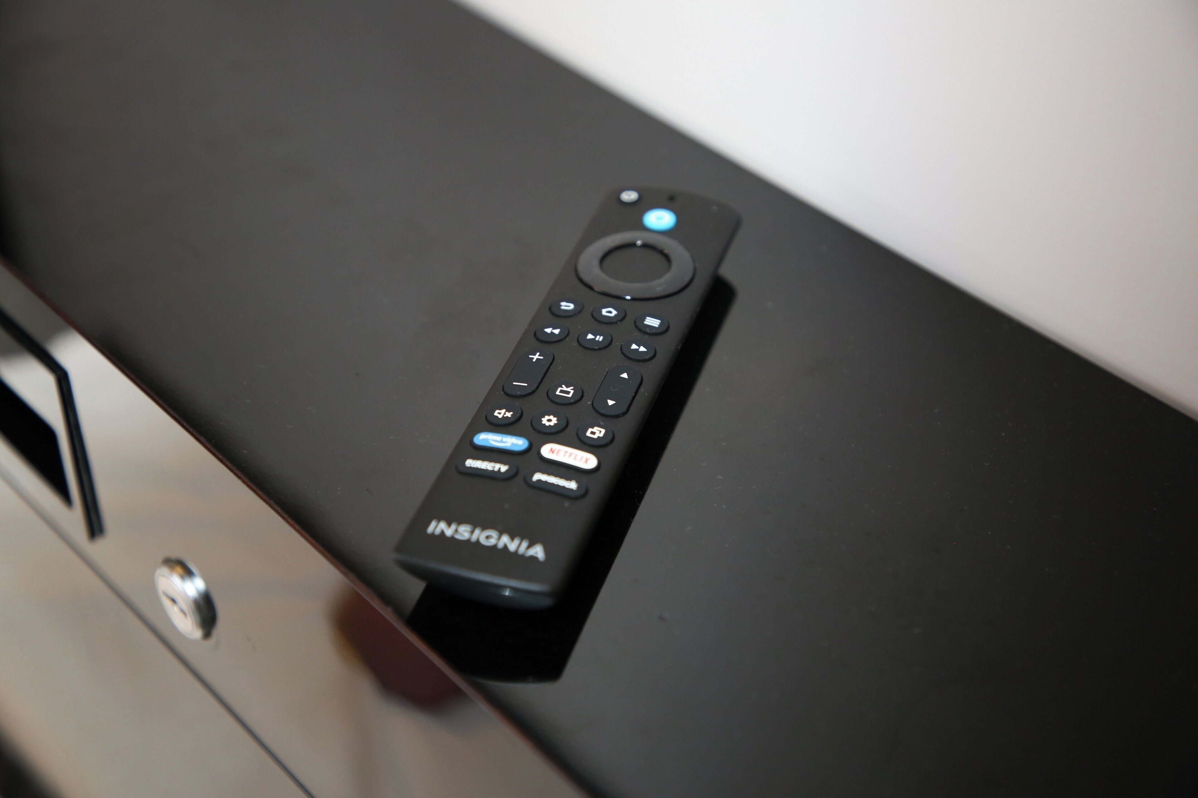 A remote control on a black surface.