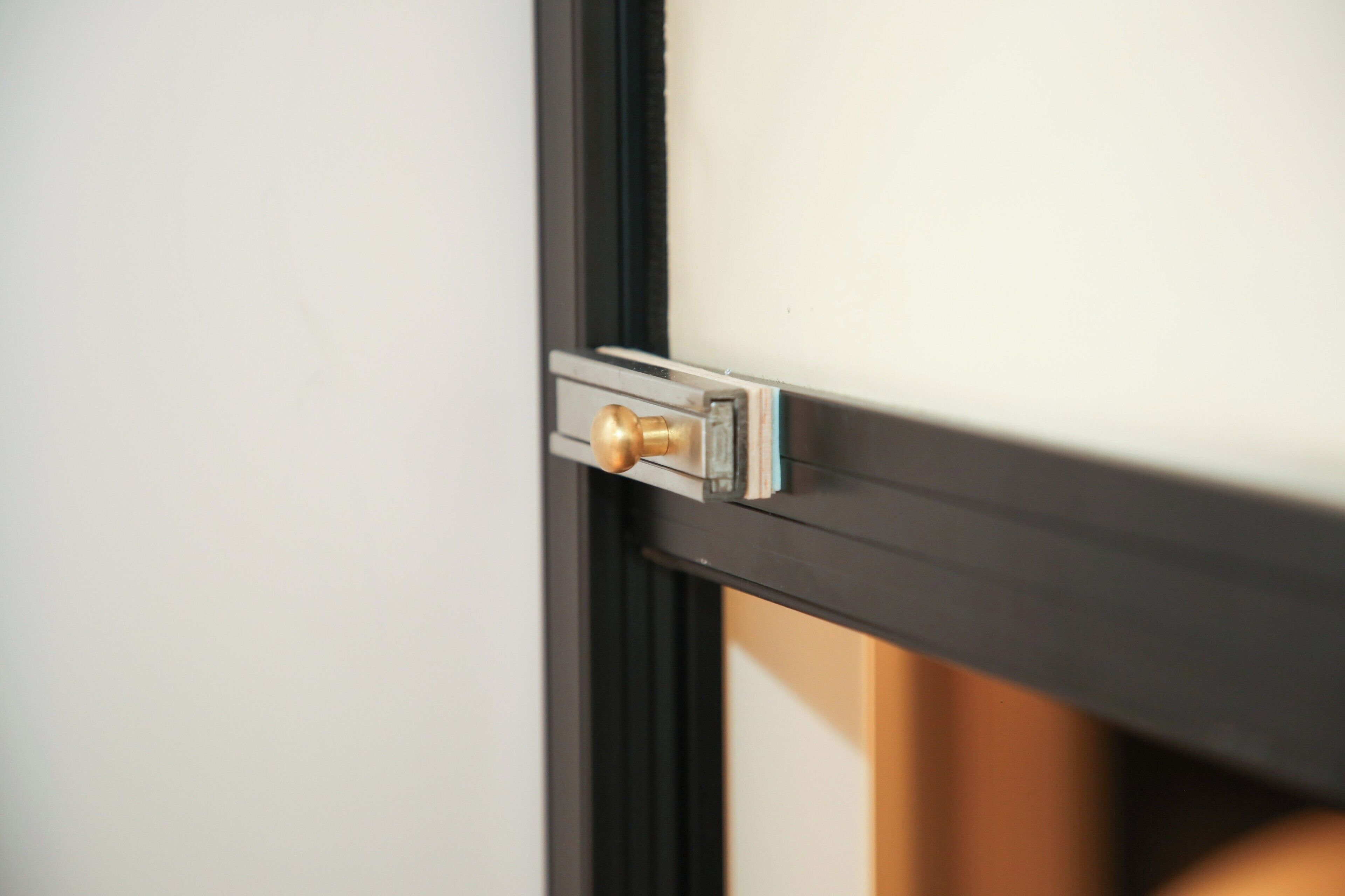 A door with a brass handle and a keyhole, suggesting a secure entry point.