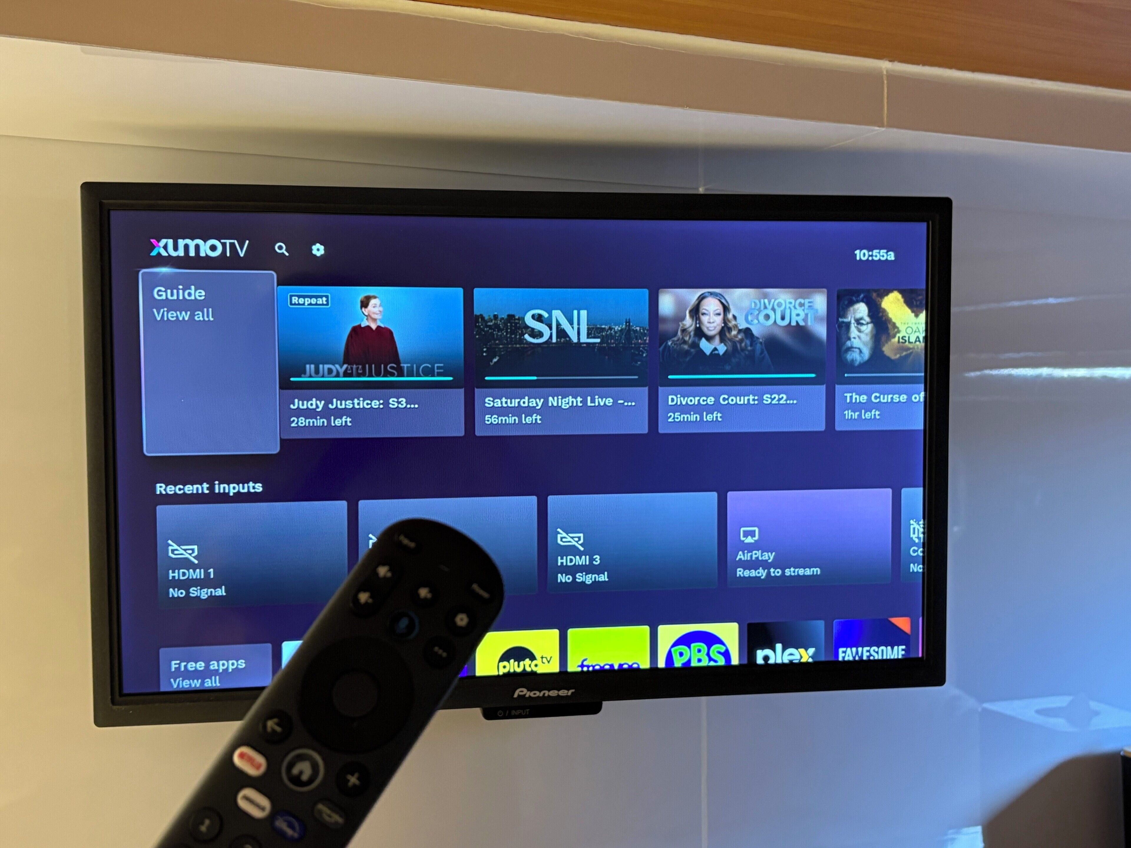 A television screen displaying a streaming service interface with various TV shows and channels.
