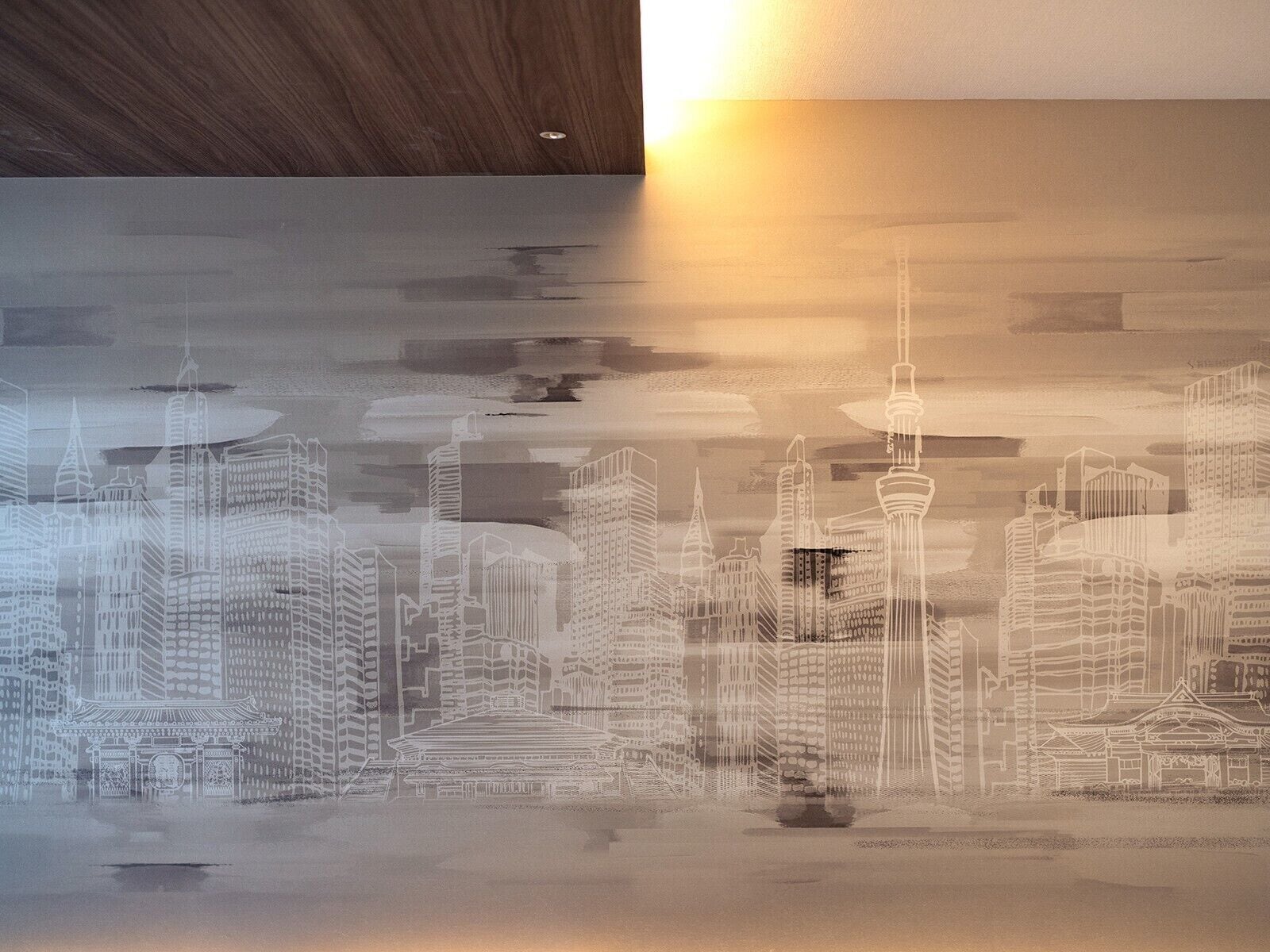 A cityscape mural with a prominent tower and traditional architecture.