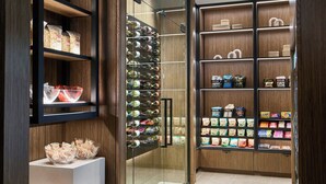 A modern kitchen with wooden cabinetry, a glass backsplash, and a variety of kitchen appliances.