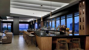 A modern kitchen with a large island, bar area, and seating.