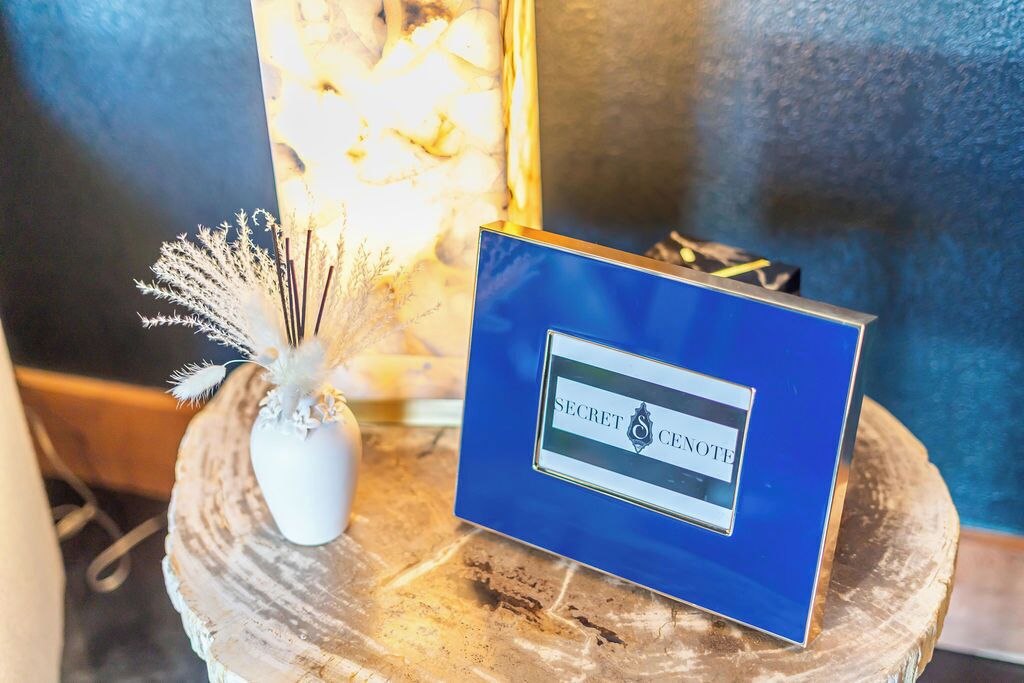 A blue sign with the text "SECRET SECRET NOTE" on a wooden surface.