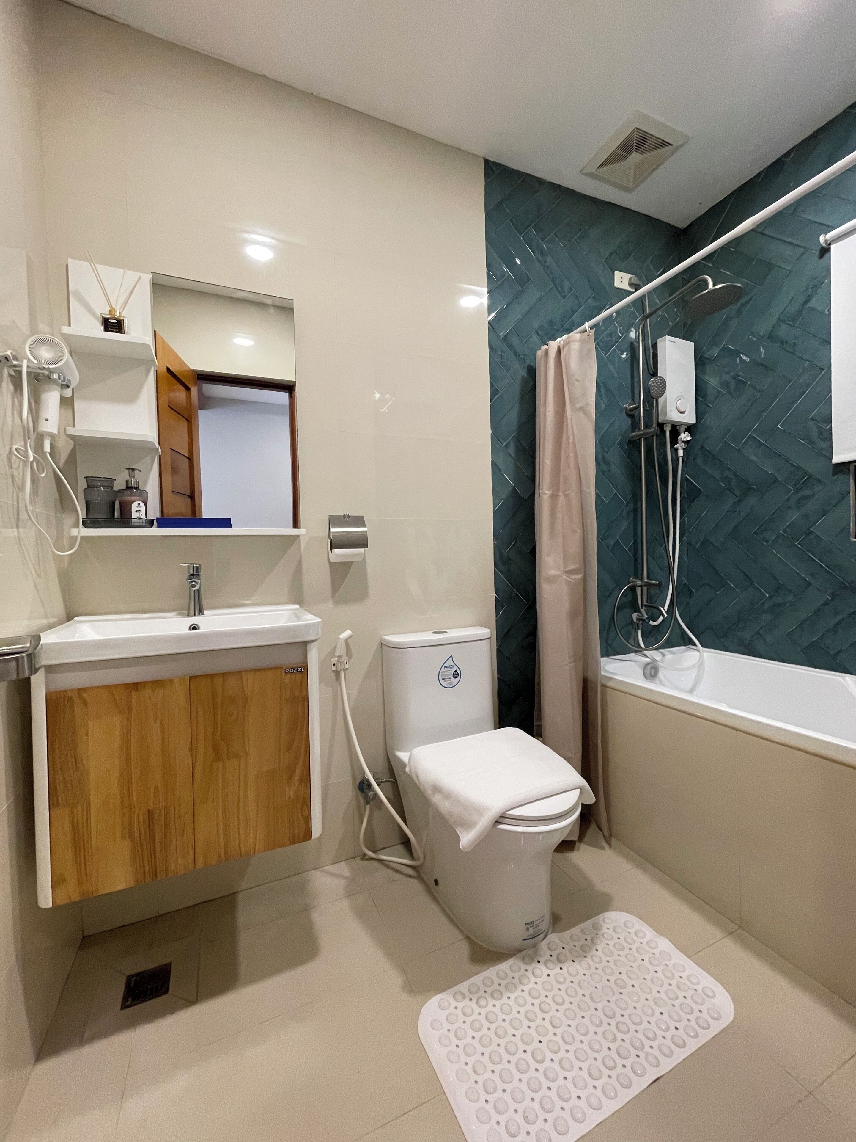A bathroom with a toilet, sink, shower, and a bathtub.