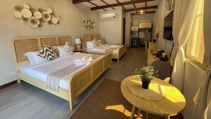 A hotel room with two beds, a small table with a plant, a desk, and a wardrobe. - The Beach Calatagan Mediterraneo powered by Cocotel (Calatagan)