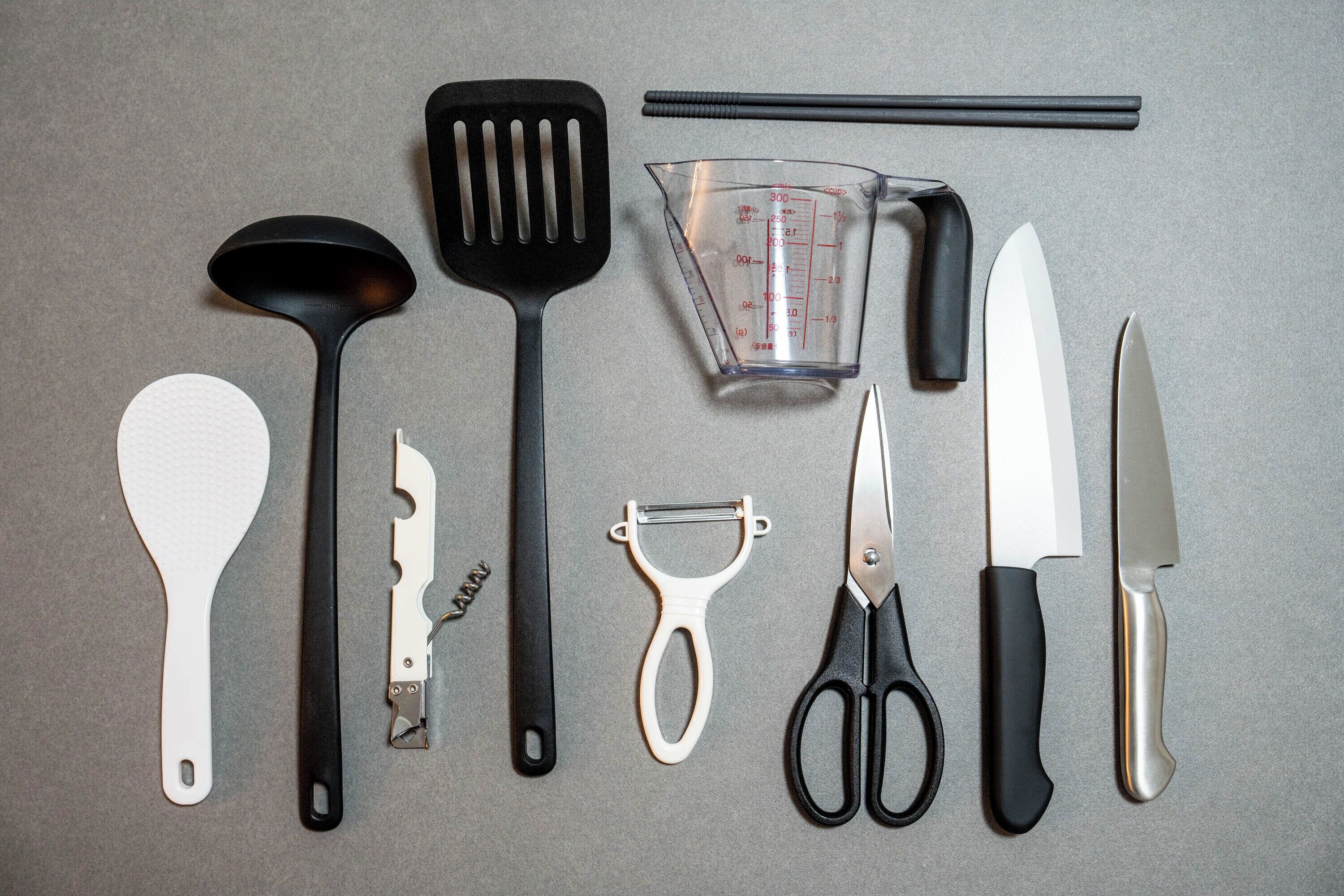 Various kitchen utensils and tools laid out on a surface.