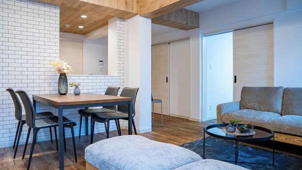 A modern living room with a wooden dining table, grey sofa, and a coffee table. - ZABO HILLS 305 (Sapporo)