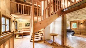 A wooden interior with a staircase, a sofa, and a table. - Mountain house "Lutzklang" (Raggal)