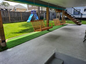 A covered patio with wooden swings and a slide. - Family Friendly
3Bath 5Beds
Relaxing Yard
Toys & Games, 4TV's
Clean Quiet Secure (Victoria)